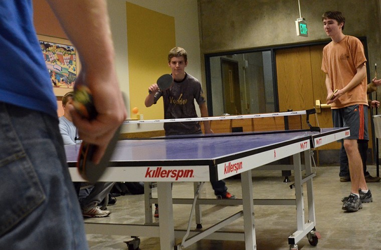 Dylan Spence (center) and Galen Richards (right) prepare to receive the ball after a serve from Ethan Batson (left) during a game of doubles at the Table Tennis Club on Nov. 5.